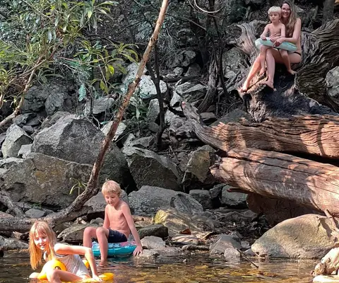 Adam's children playing in a river pool during a family outing